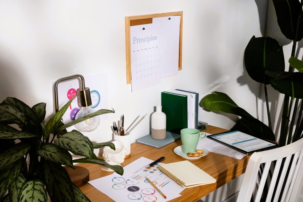 Sunlit home office desk with smart organizer tools, calendar, plants, and natural wood accents promoting productivity and well-being