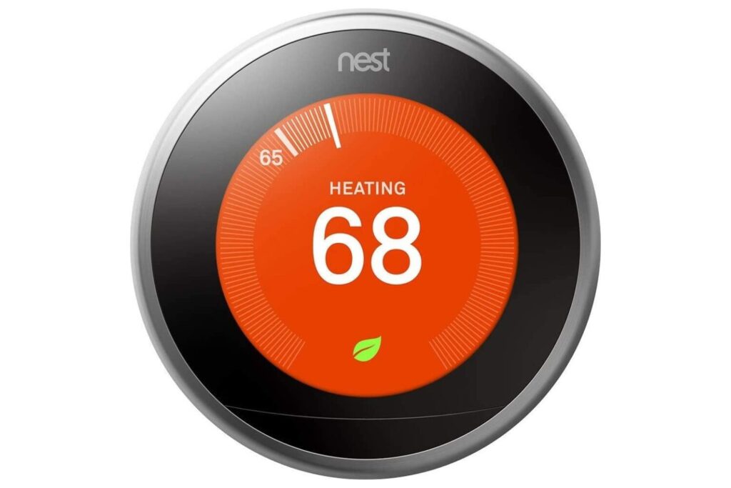 A Nest smart thermostat displaying a temperature of 68 degrees Fahrenheit, indicating an energy-efficient heating setting for optimal productivity