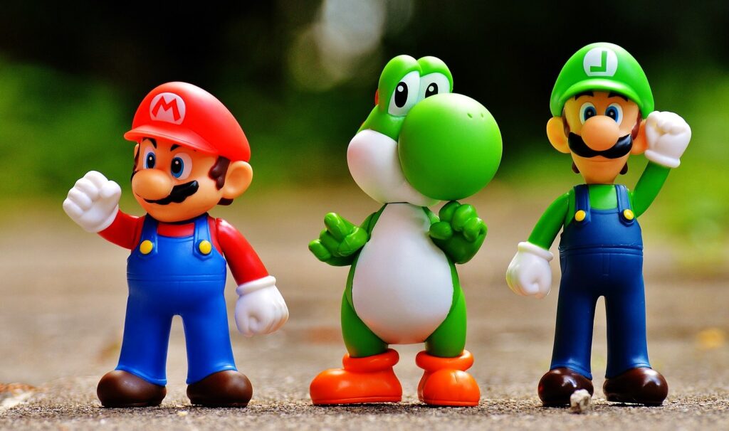 Three figurines of iconic Nintendo characters Mario, Yoshi, and Luigi standing in a row, representing the nostalgia and joy of retro gaming