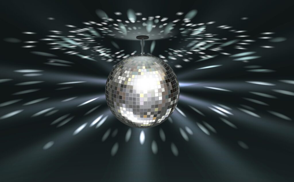 A silver disco ball hanging from the ceiling, reflecting light in all directions and creating a festive atmosphere